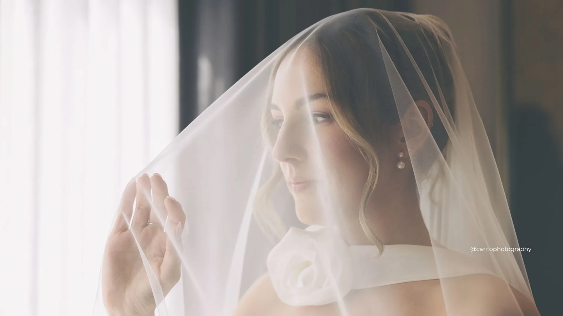 Soft bridal portrait beneath a sheer veil by Angie Mendoza Bridal