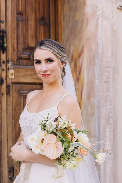 Bride styled with a polished updo and soft glam makeup