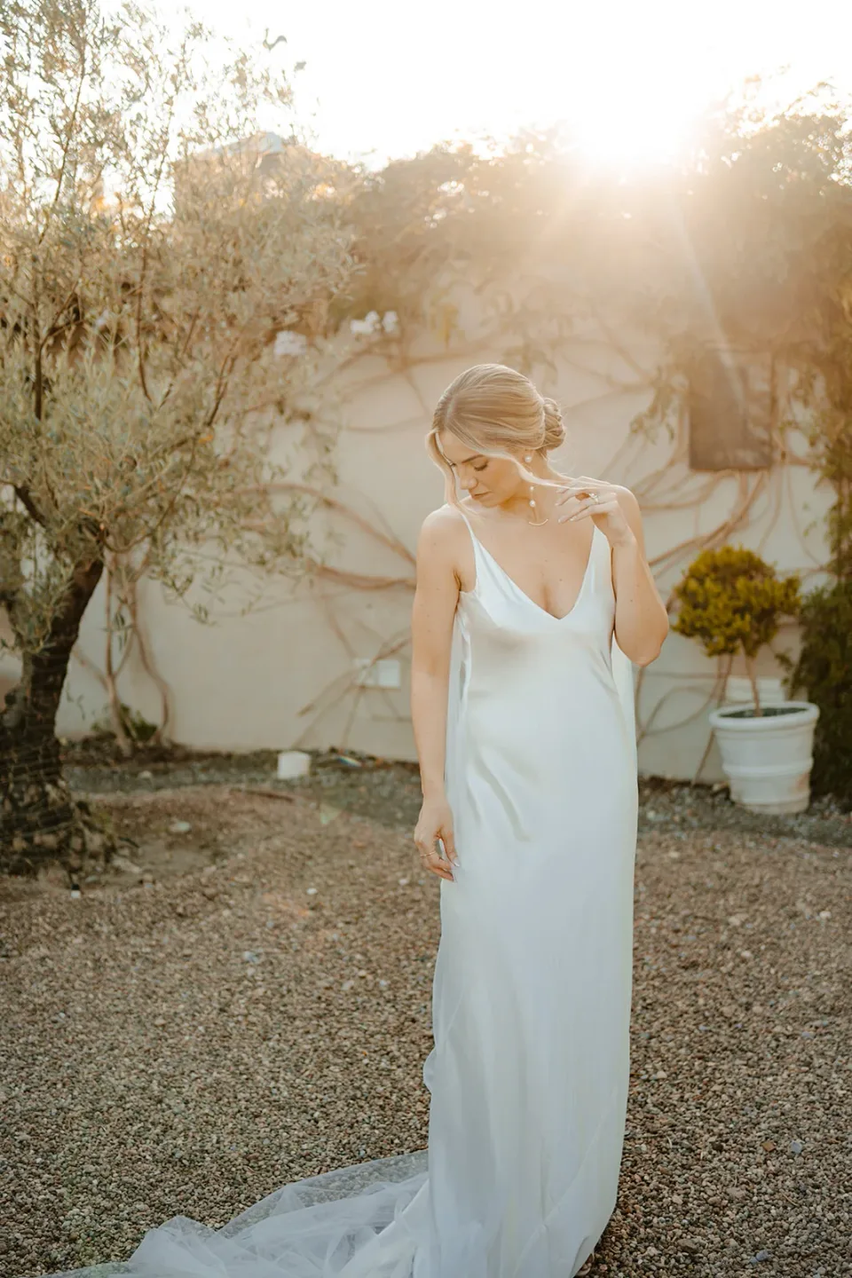 Sunlit bride showing soft wedding makeup and an elegant updo