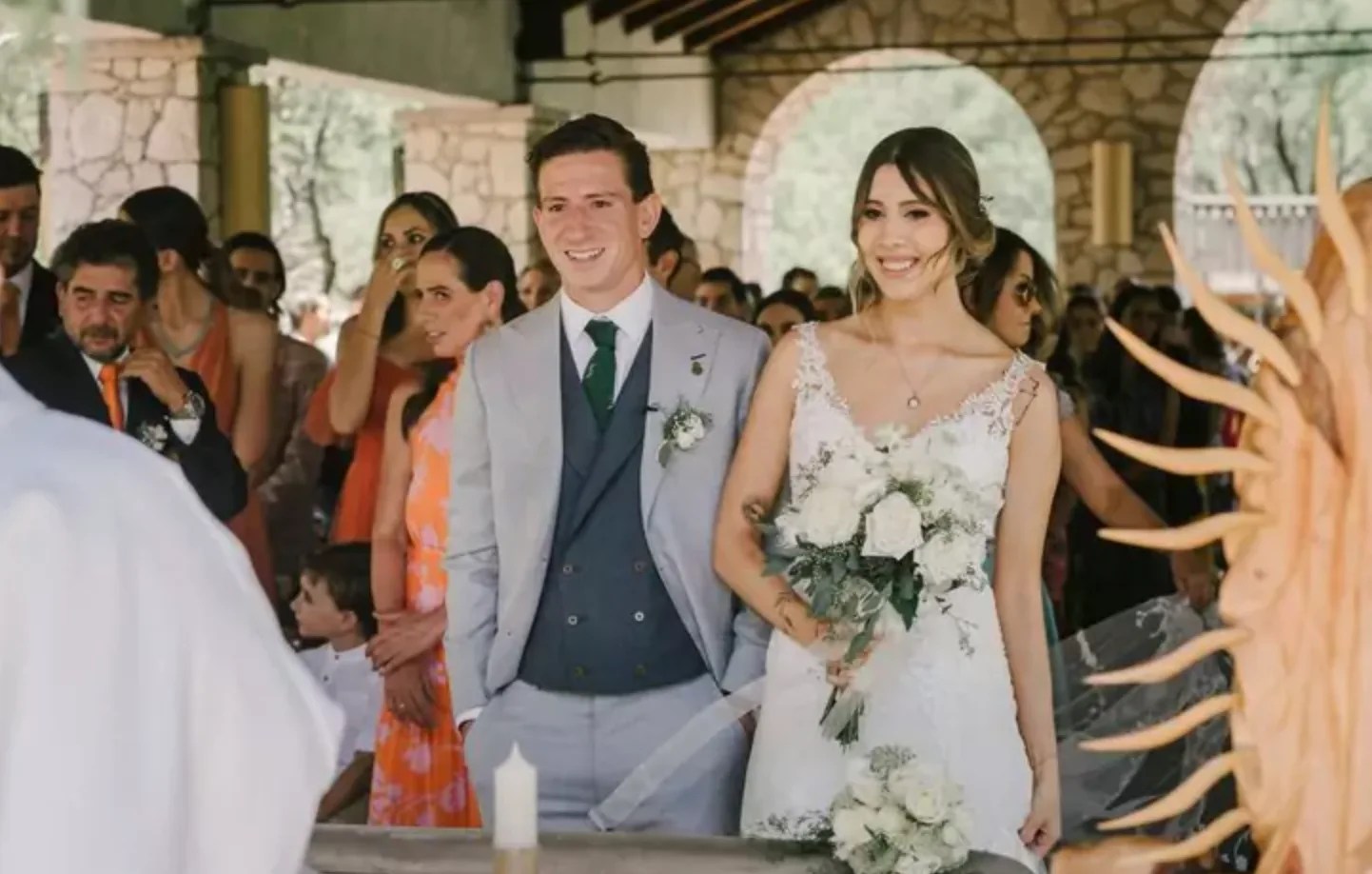 Newlyweds smiling together during an outdoor wedding ceremony