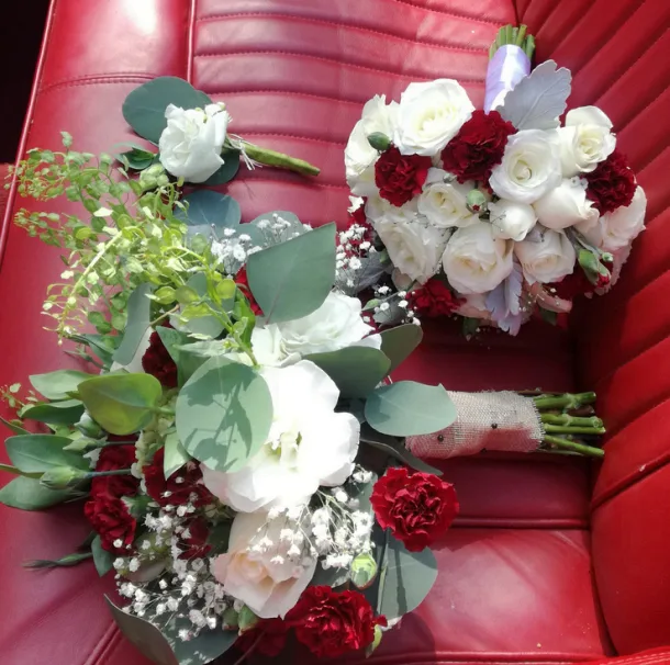 Coordinated wedding bouquets and boutonniere in white and deep red