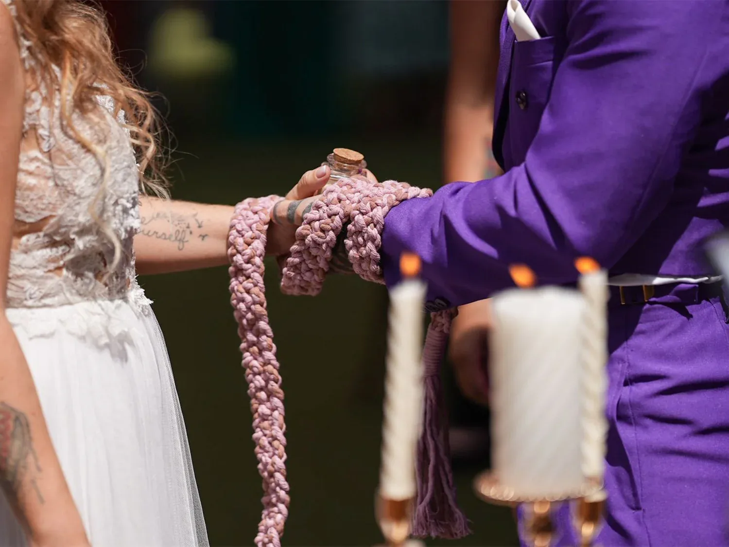 Couple taking part in a handfasting ritual
