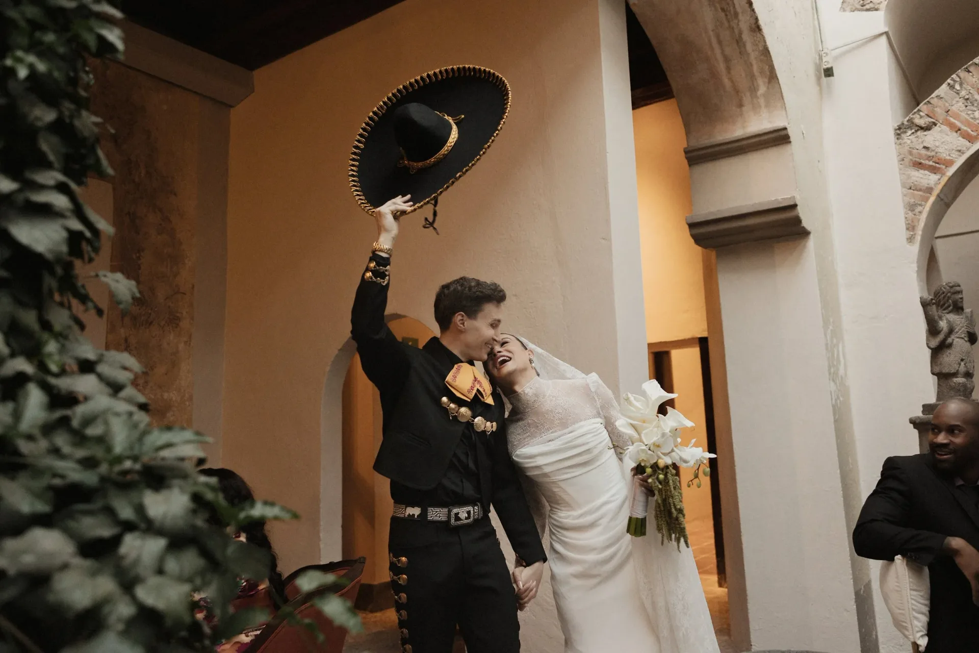 Couple celebrating alongside mariachi musicians