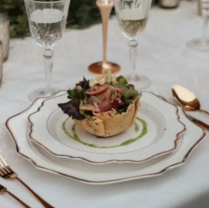 Refined plated wedding course presented with crystal stemware and gold flatware