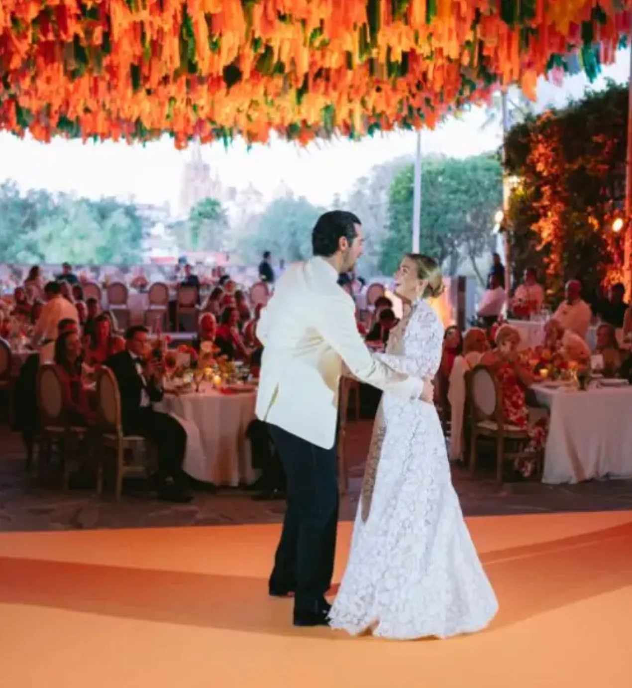Newlyweds sharing their first dance beneath vibrant suspended décor at a Penzi wedding