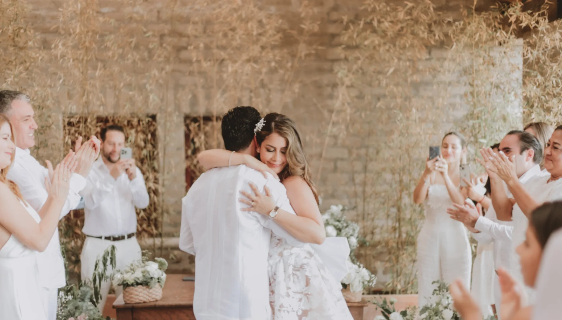 Newlyweds embracing during an intimate ceremony surrounded by their guests