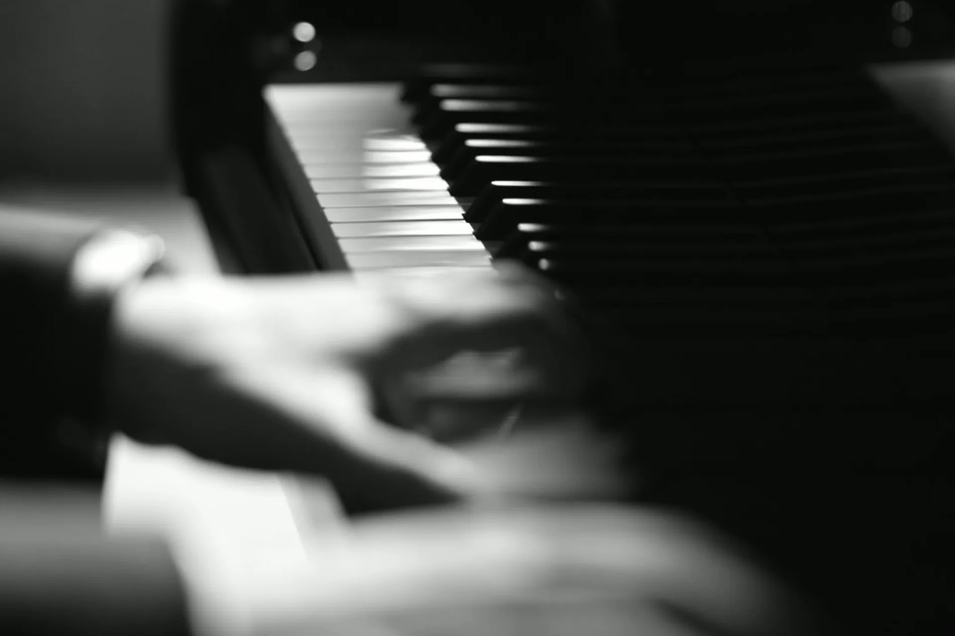 Cinematic close-up of hands playing piano