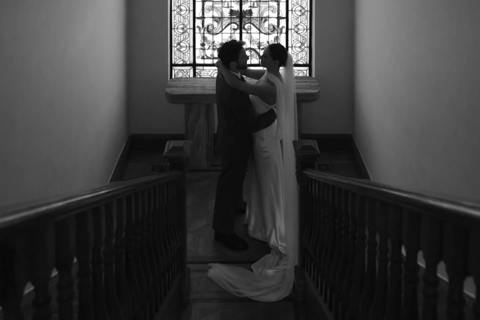 Wedding couple silhouetted in a dramatic interior