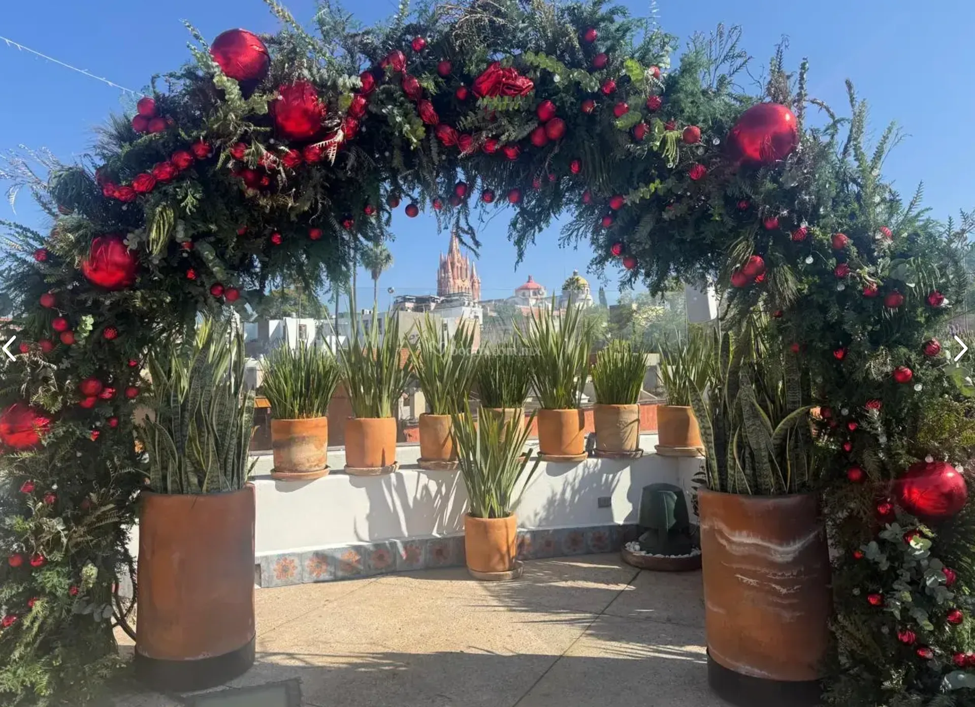 Holiday floral arch framing the San Miguel skyline from Casa 1810