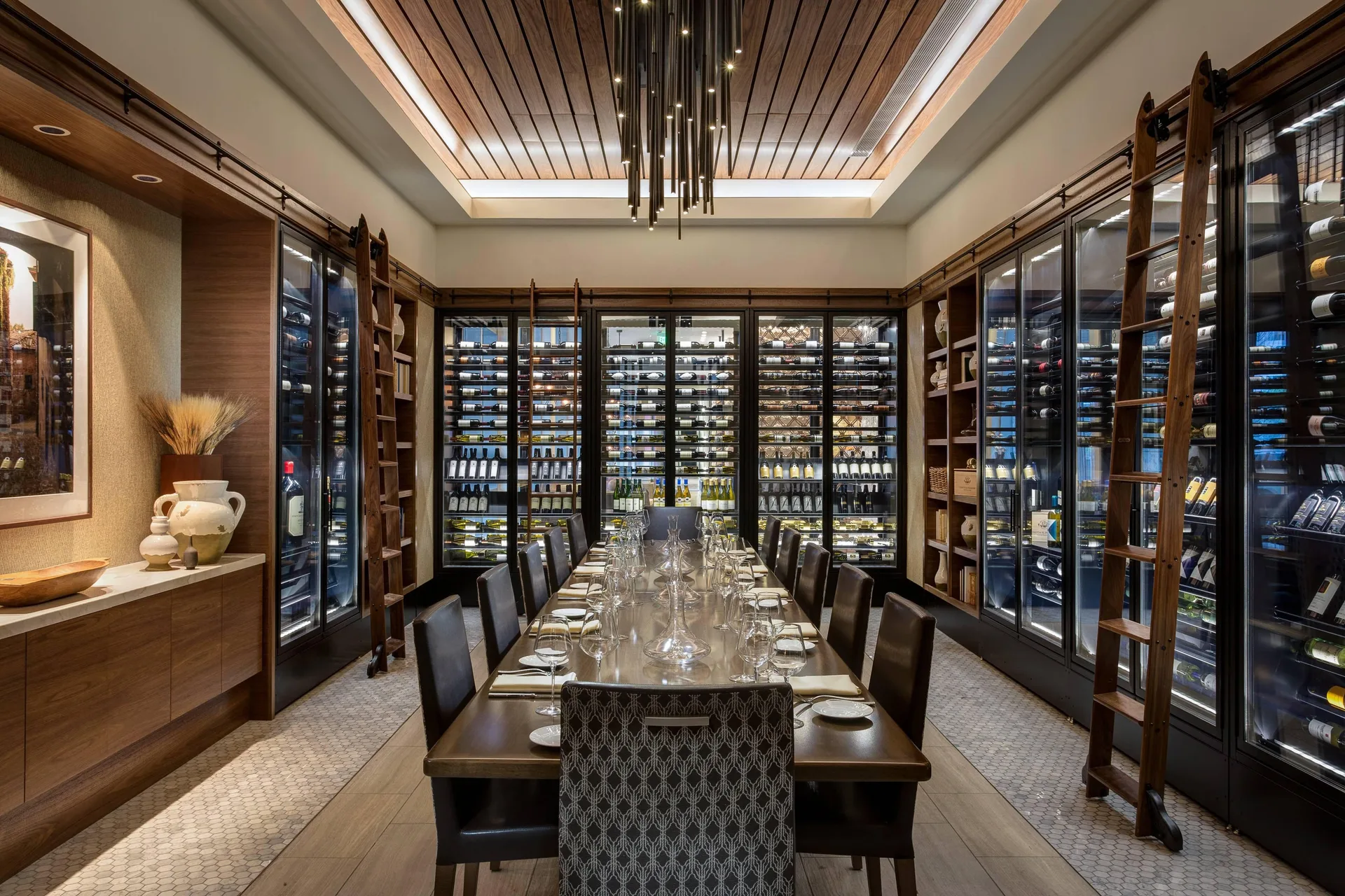 Private wine room with a long dining table at Cleviá San Miguel de Allende