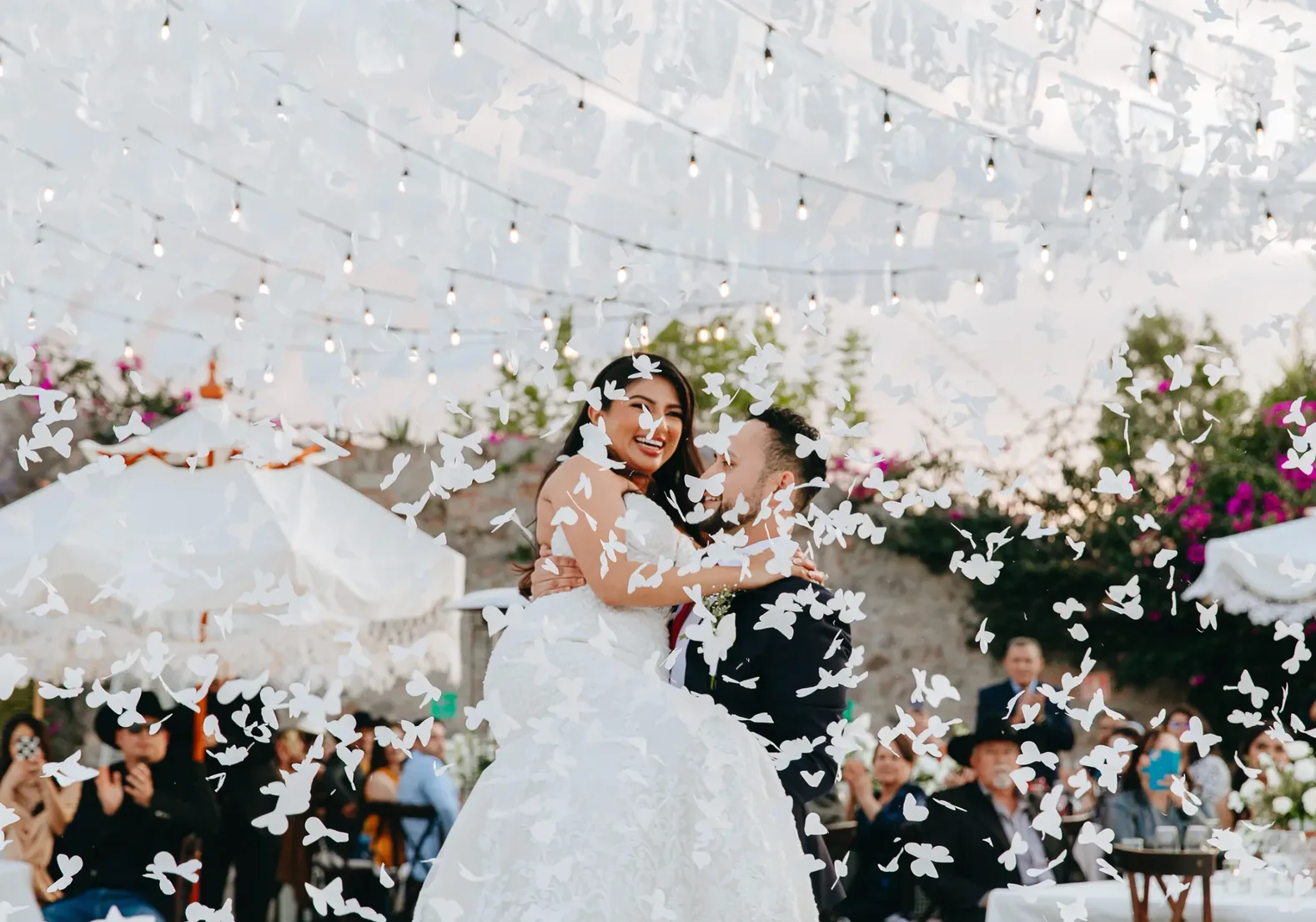 Newlyweds celebrating beneath string lights at Hacienda Agualuna