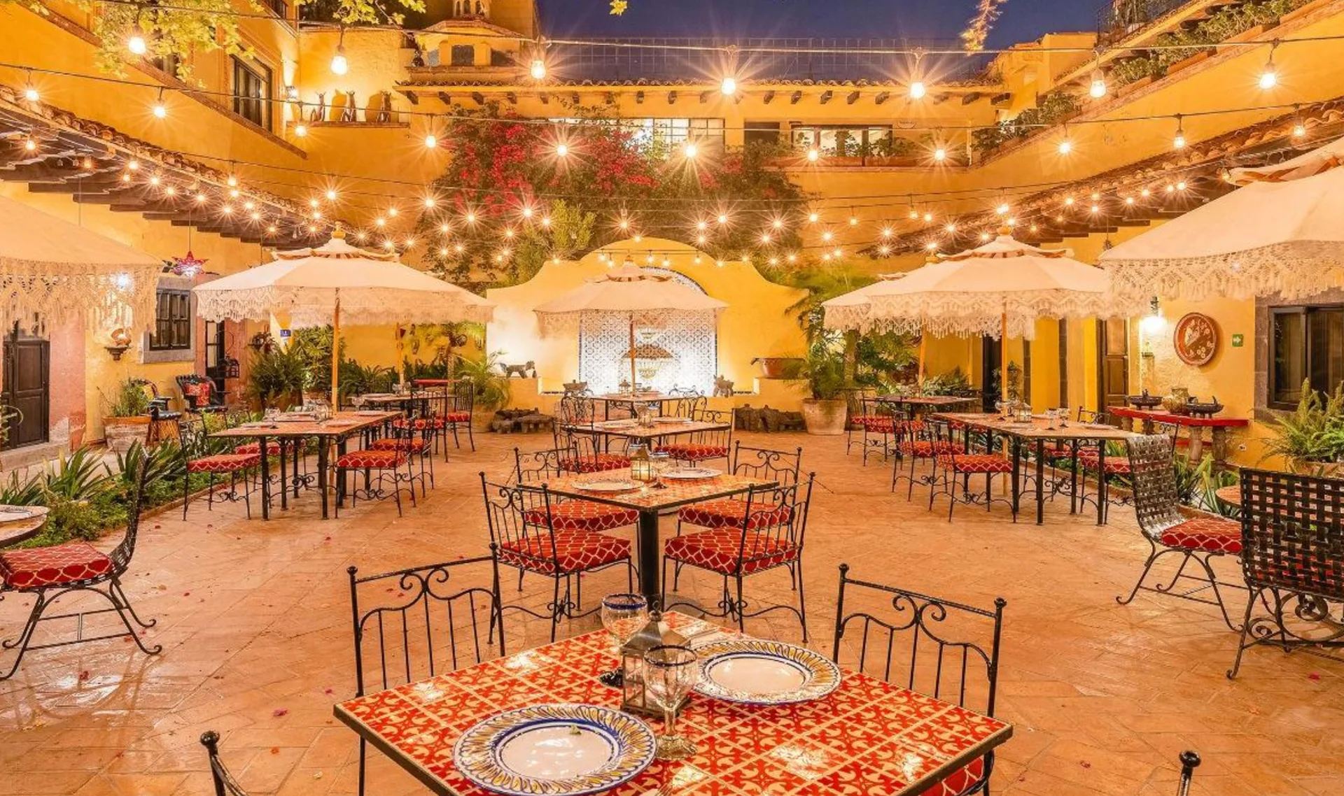 Hacienda El Santuario central courtyard illuminated for an evening celebration