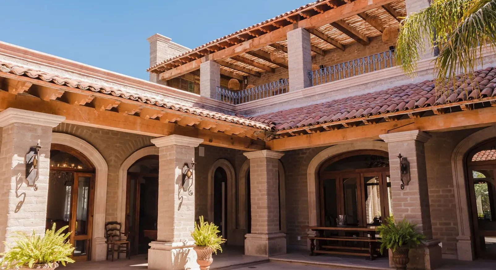 Colonial courtyard with stone arches and covered terraces