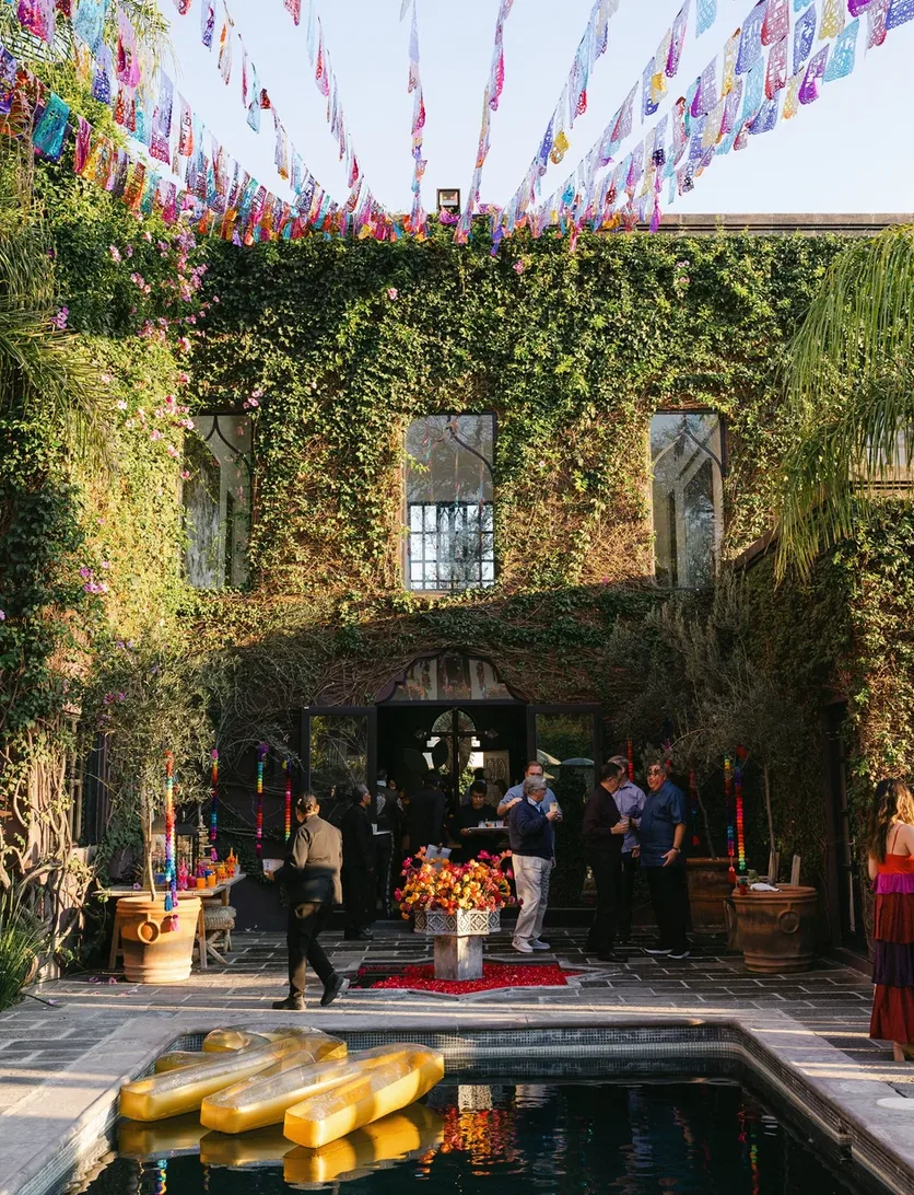 Ivy-covered courtyard decorated with colorful papel picado at Hacienda Santa Ana