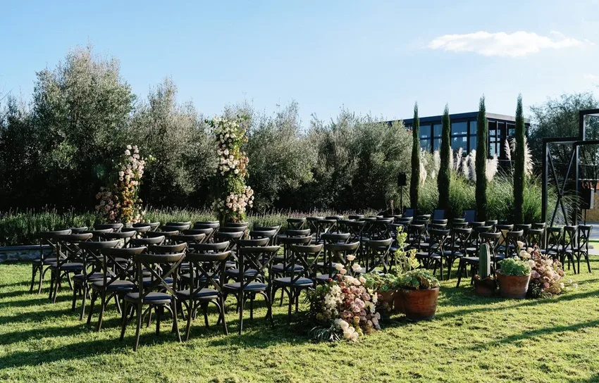Outdoor wedding ceremony arranged on the event lawn at Hacienda Santa Ana