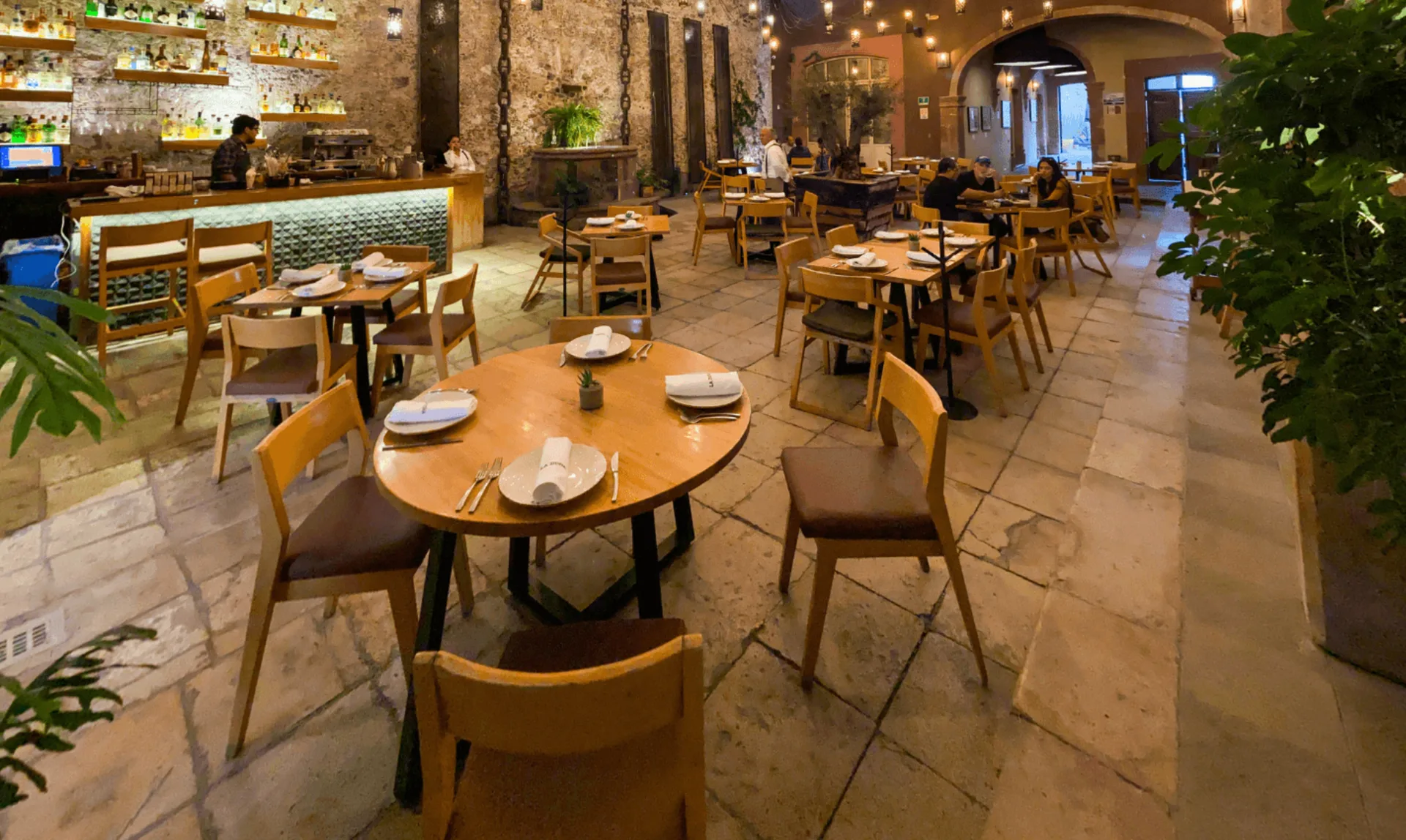 Stone-walled restaurant courtyard and bar at Hotel Nena