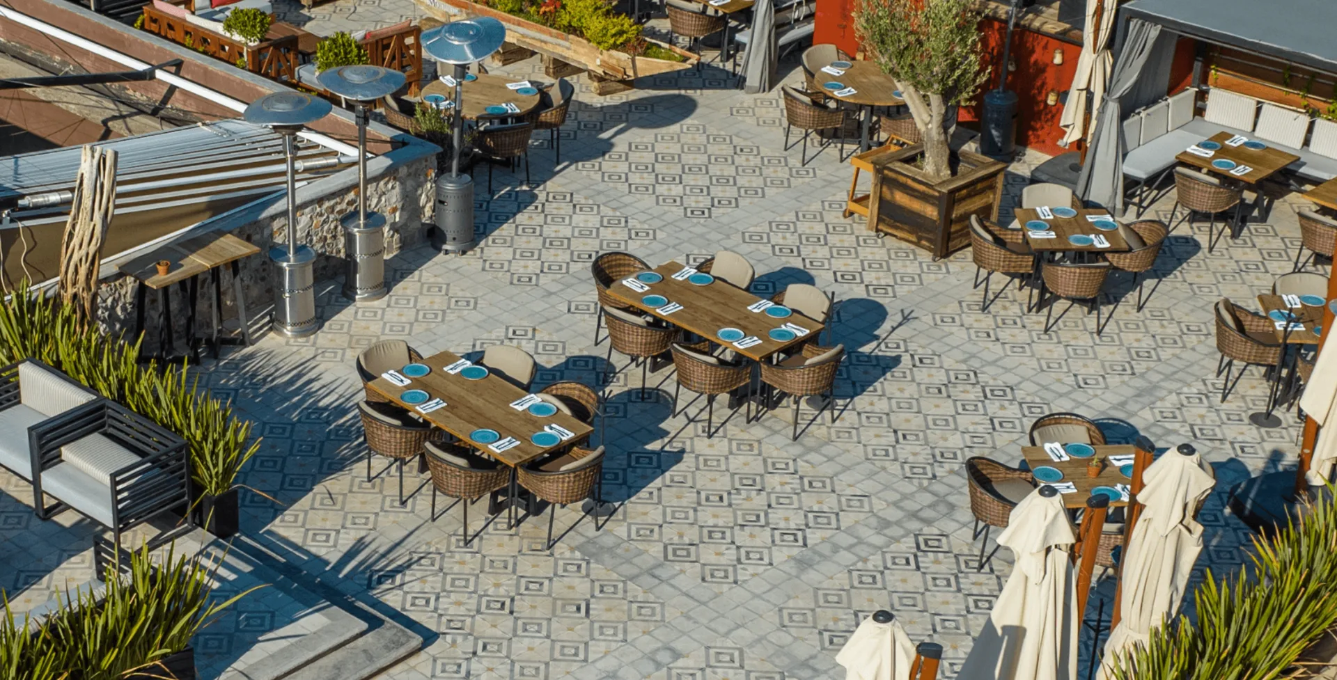 Open-air rooftop terrace arranged with dining tables at Hotel Nena
