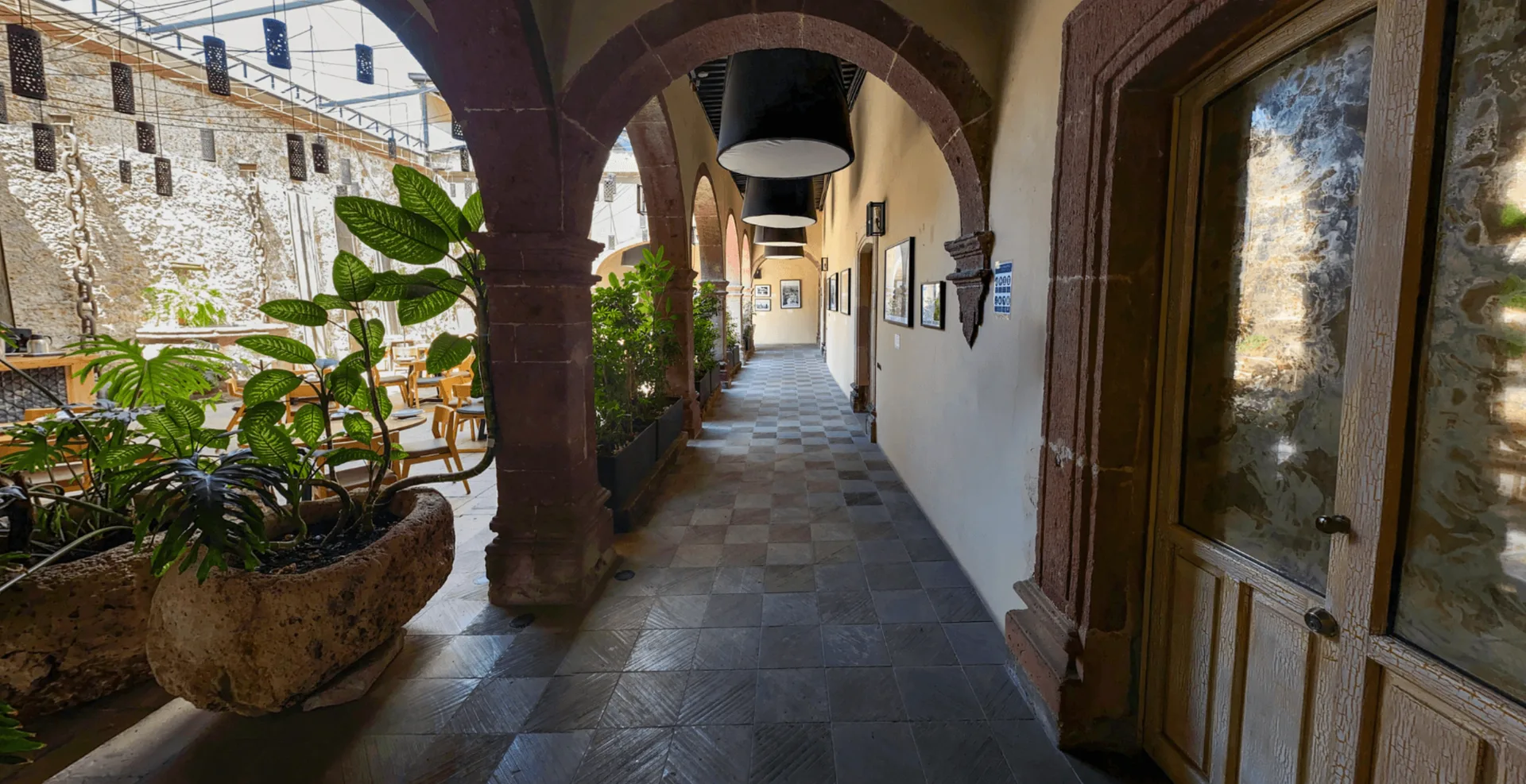 Historic stone arcade overlooking the restaurant courtyard at Hotel Nena