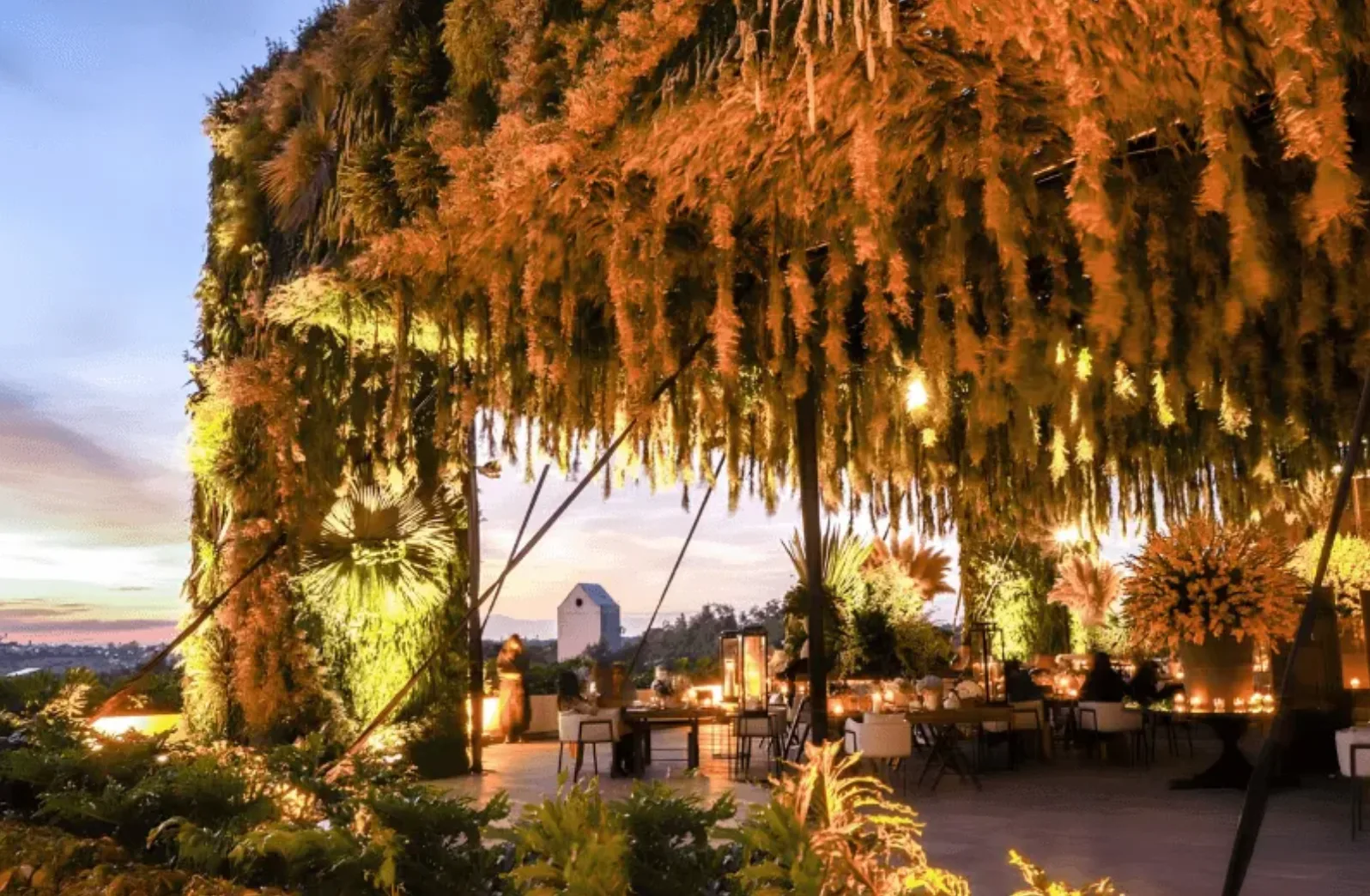 Evening garden reception beneath a dramatic floral canopy at Live Aqua