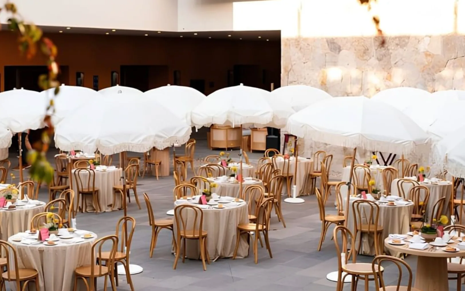 Outdoor reception tables shaded by white parasols at Live Aqua