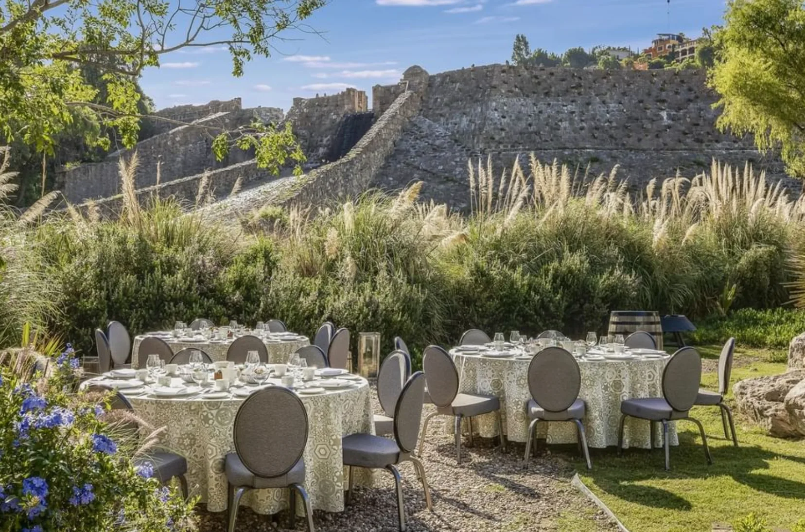 Garden dining setup overlooking the historic Presa del Obraje