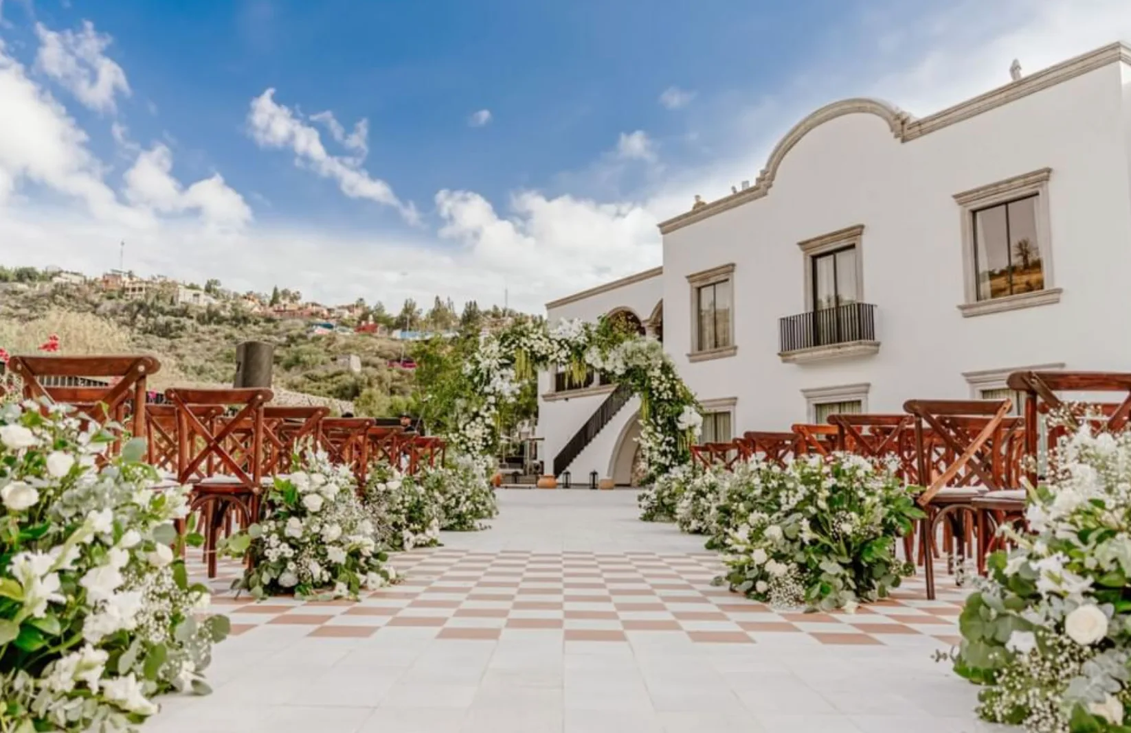 Outdoor wedding ceremony with white florals at Live Aqua San Miguel de Allende